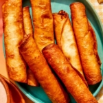 Close up on a bowl of freshly made flautas.
