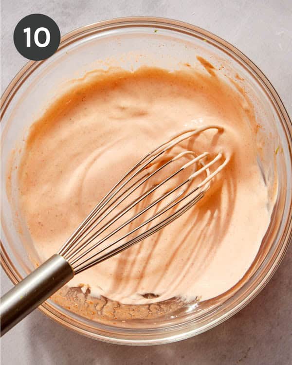 Spicy flautas dipping sauce in a glass bowl whisked together.
