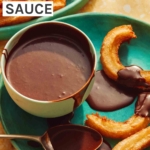 A plate with churros and a bowl of homemade chocolate sauce.
