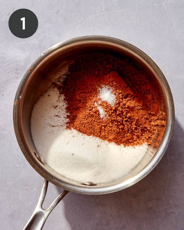 A pot with sugar and cocoa powder in it to make chocolate sauce.