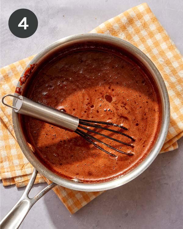 Chocolate sauce in a pot being cooked.
