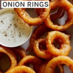Close up on beer battered onion rings with ranch.