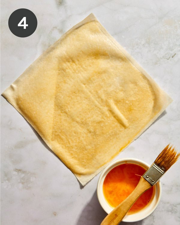 Spring roll wrapper brushed with an egg wash.