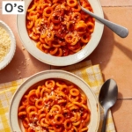 Homemade Spaghetti Os in two bowl with parmesan on the side.