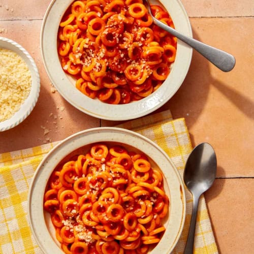 Homemade Spaghetti Os in two bowl with parmesan on the side.