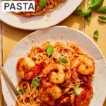 Tomato butter pasta on two plates with a fork in one.