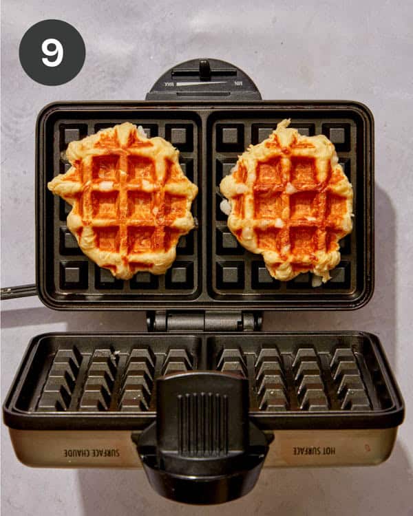 Freshly cooked liege waffles on a waffle iron.