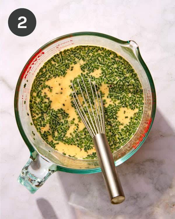 An egg mixture with chives for a croissant bake.