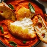 Fried burrata over romesco sauce with bread.