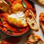 Fried burrata over romesco sauce with bread.