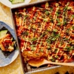 Salmon sushi bake in a baking dish with a spoon in it.