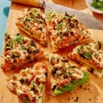 Sushi pizza recipe on a cutting board.