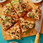 Sushi pizza recipe on a cutting board.