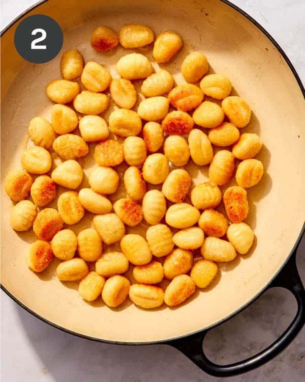 Pan fried gnocchi in a pan.