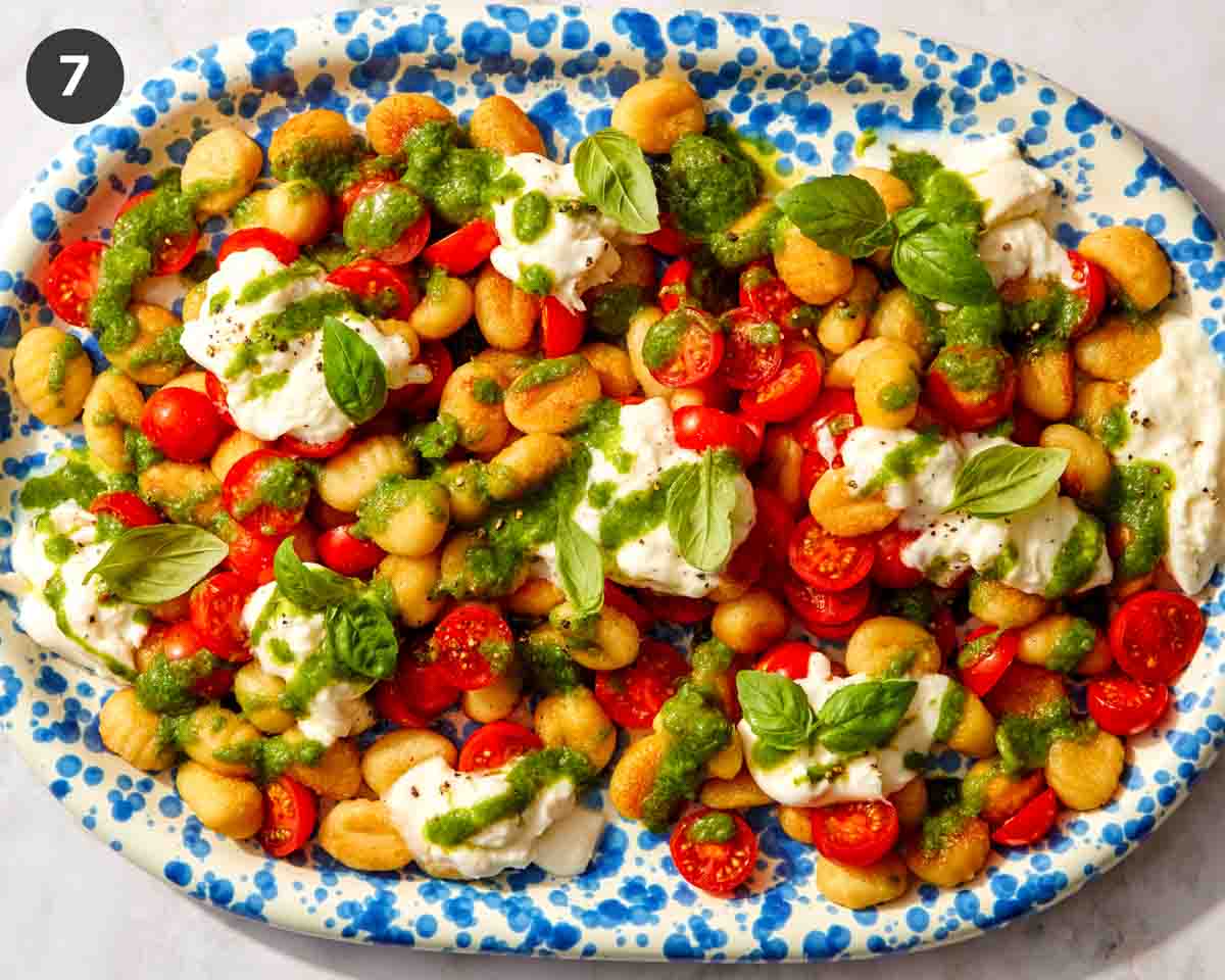 A finished platter of pan of fried gnocchi ready to be served.