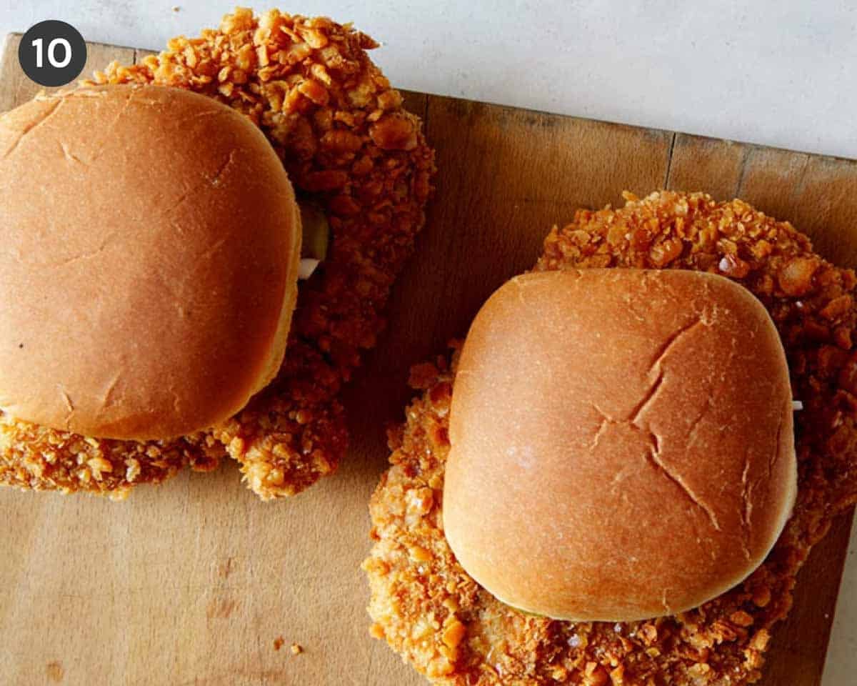Overhead image of two pork tenderloin sandwiches on a cutting board.