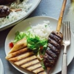 Lamb kofta recipe on a plate with rice and pita.
