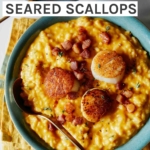 Pumpkin risotto with seared scallops on top in a bowl with a spoon in it.